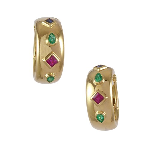 Pair of gold, emerald, ruby and sapphire hoop earrings by Cartier, the bold gold C scrolls inset to front with four variously shaped gems,
